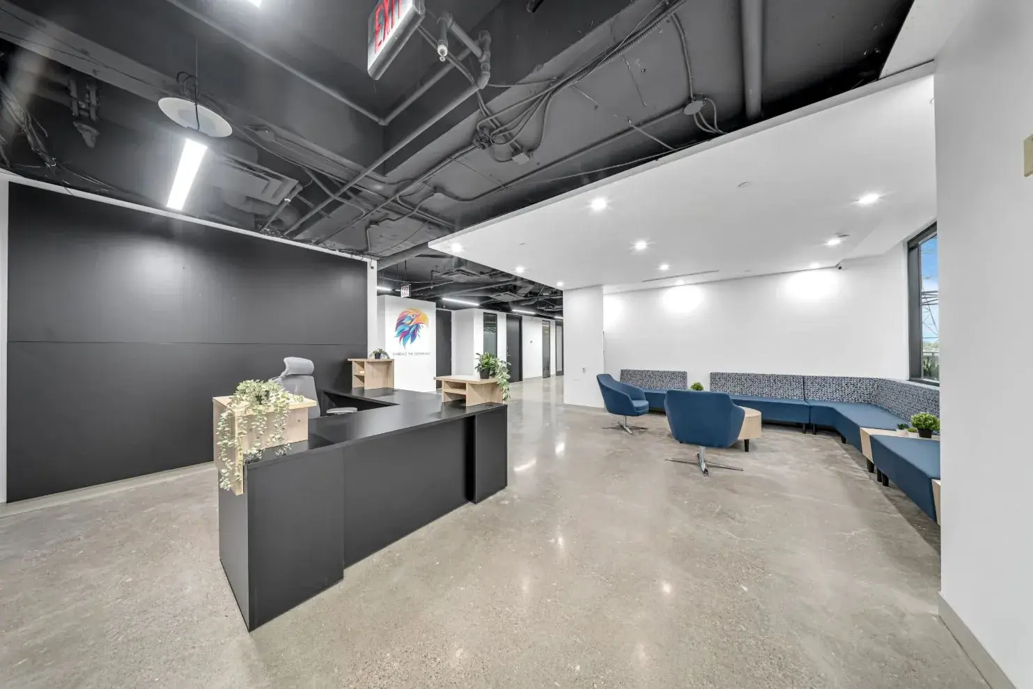Reception area with an exposed open ceiling at the Workplace K office build-out, 5700 Yonge St, Toronto